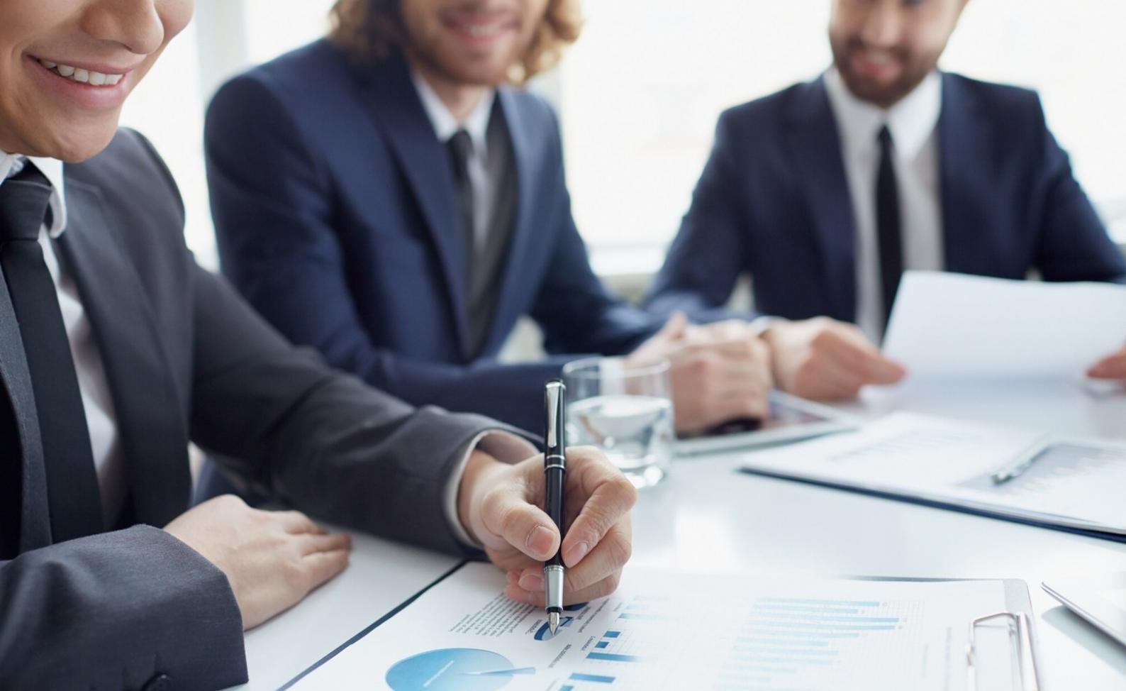 Professional advisor reviewing financial monitoring tools with student